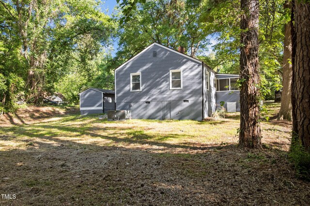 1613 Kilmer Ter, Durham, NC 27703 - view of side of property featuring a chimney, a sunroom, central air condition unit, and crawl space
