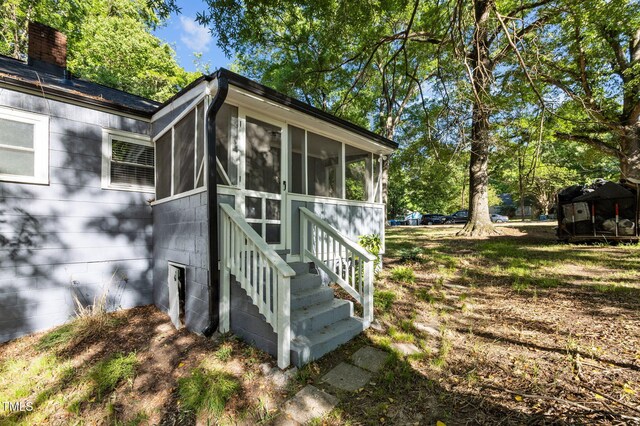 1613 Kilmer Ter, Durham, NC 27703 - exterior space with a chimney and a sunroom