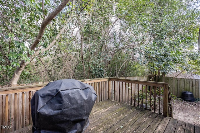 wooden deck featuring grilling area and a fenced backyard