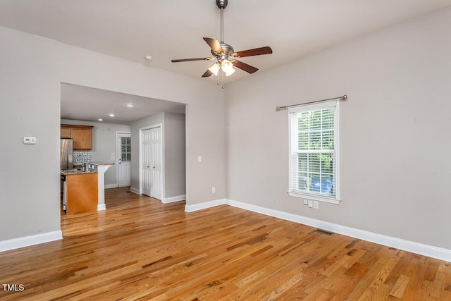 305 Freeman St, Raleigh, NC 27601 - unfurnished living room featuring a ceiling fan, light wood-style flooring, baseboards, and recessed lighting