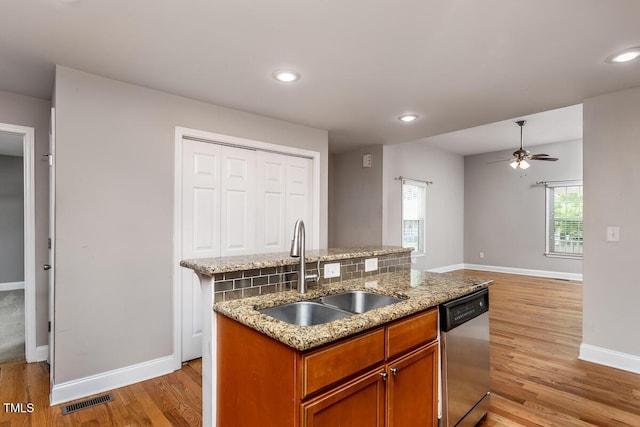 305 Freeman St, Raleigh, NC 27601 - kitchen with stainless steel dishwasher, a sink, light wood finished floors, baseboards, and recessed lighting