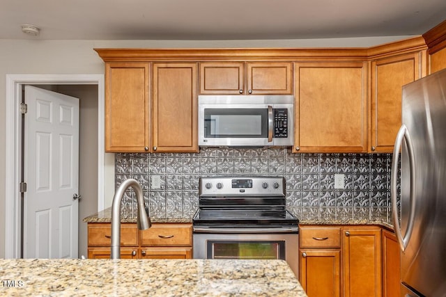 305 Freeman St, Raleigh, NC 27601 - kitchen featuring appliances with stainless steel finishes and brown cabinets