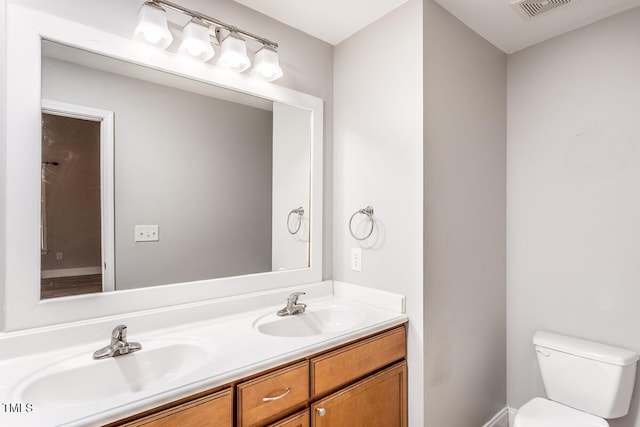 305 Freeman St, Raleigh, NC 27601 - bathroom featuring toilet, double vanity, and baseboards