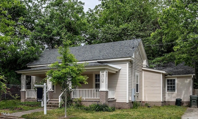 305 Freeman St, Raleigh, NC 27601 - view of front of house featuring roof with shingles, a porch, and fence