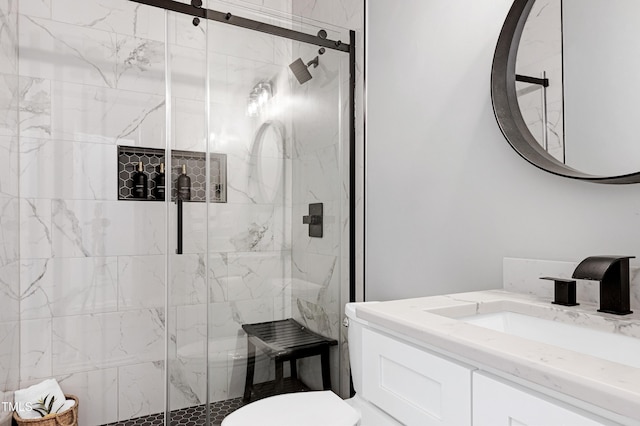 bathroom with a marble finish shower, toilet, and vanity