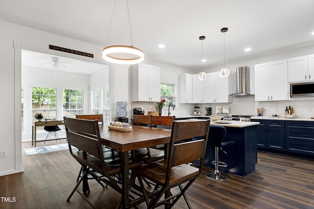 dining room featuring dark wood-style flooring, plenty of natural light, a ceiling fan, and recessed lighting