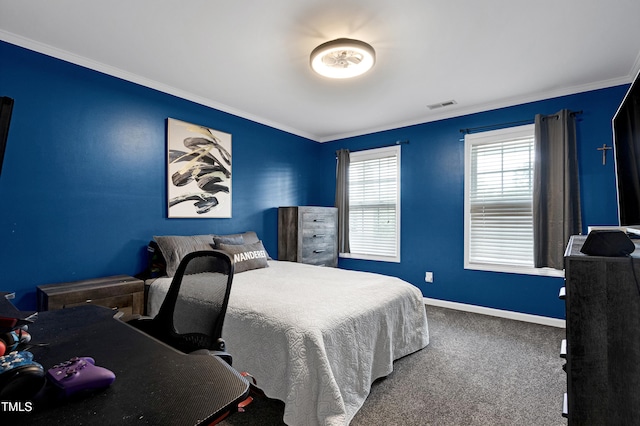 carpeted bedroom with ornamental molding and baseboards