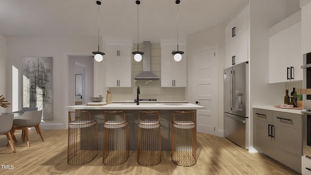 1800 Pershing Rd, Raleigh, NC 27608 - kitchen with stainless steel fridge, wall chimney range hood, light wood-style flooring, and light countertops