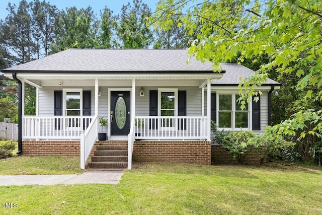 2402 Cynthia Dr, Durham, NC 27704 - view of front of property with a front lawn, a shingled roof, and covered porch