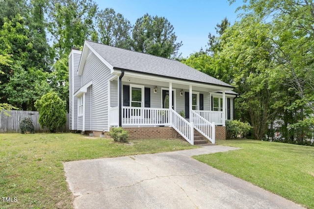 2402 Cynthia Dr, Durham, NC 27704 - single story home featuring a chimney, fence, a porch, and a front yard