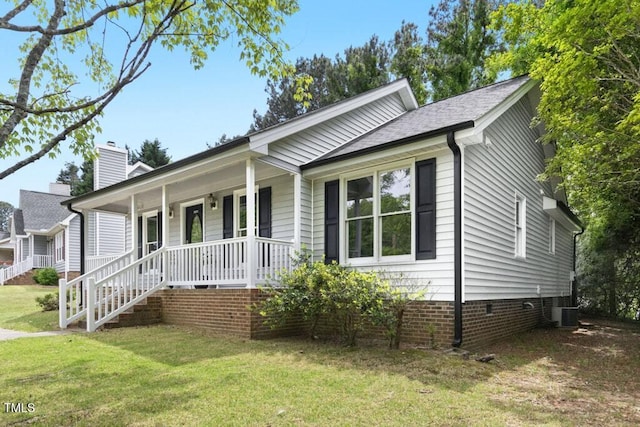 2402 Cynthia Dr, Durham, NC 27704 - ranch-style house with cooling unit, a chimney, covered porch, crawl space, and a front yard