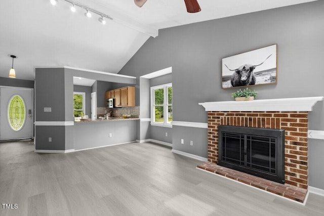 2402 Cynthia Dr, Durham, NC 27704 - unfurnished living room featuring a ceiling fan, wood finished floors, beam ceiling, and a fireplace