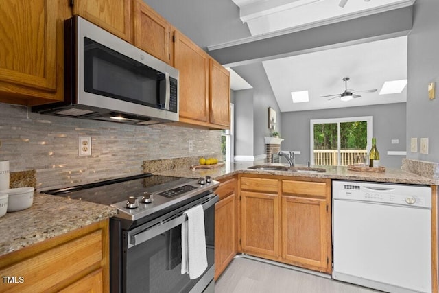 2402 Cynthia Dr, Durham, NC 27704 - kitchen featuring stainless steel appliances, backsplash, a sink, light stone countertops, and a peninsula