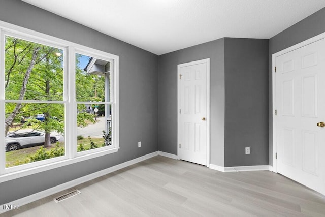 2402 Cynthia Dr, Durham, NC 27704 - unfurnished bedroom featuring baseboards, visible vents, and light wood-type flooring