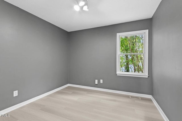 2402 Cynthia Dr, Durham, NC 27704 - unfurnished room featuring wood finished floors, visible vents, and baseboards