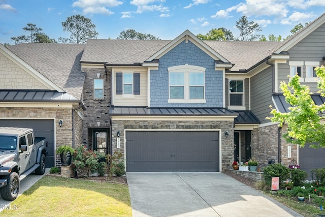 view of front facade with a standing seam roof, a shingled roof, and concrete driveway