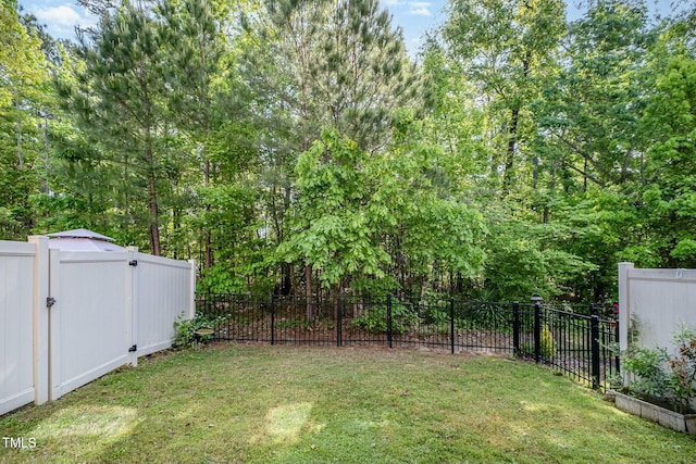view of yard with a gate and a fenced backyard