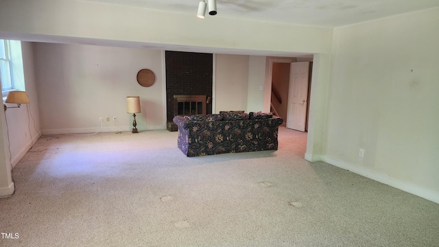 113 Colonial Dr, Wendell, NC 27591 - carpeted living area with a fireplace, stairs, and baseboards