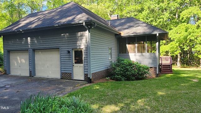 113 Colonial Dr, Wendell, NC 27591 - view of home's exterior featuring a sunroom, a shingled roof, a chimney, and a lawn