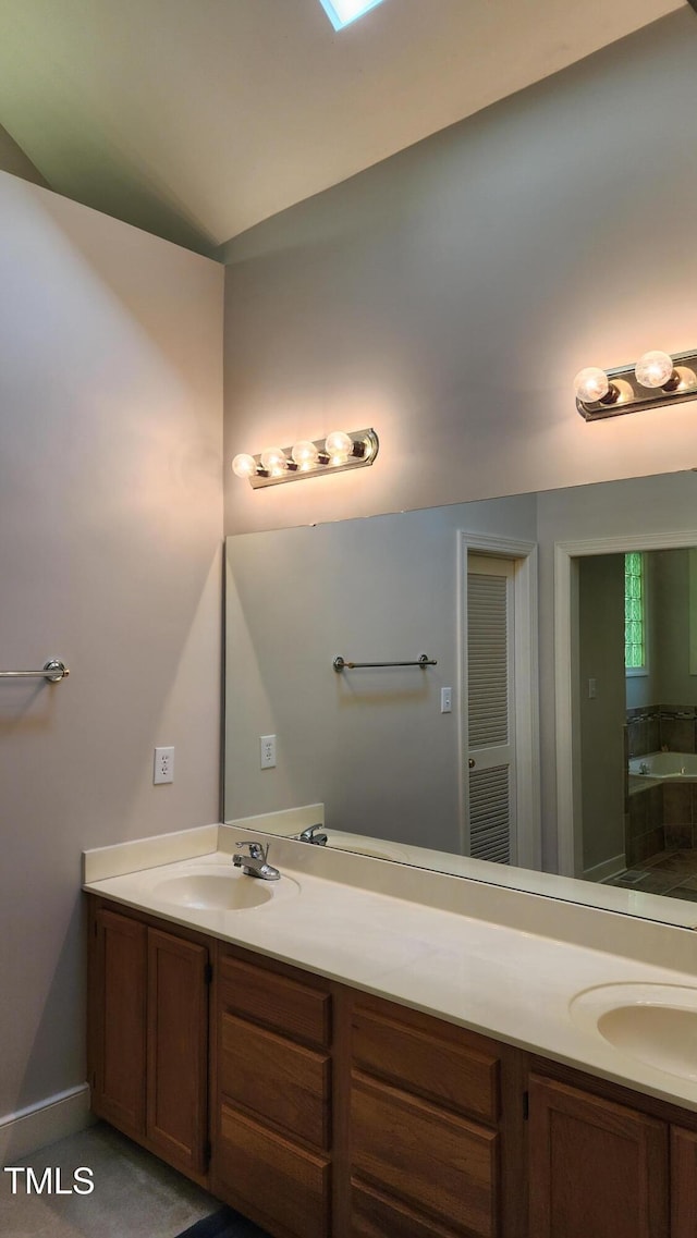 113 Colonial Dr, Wendell, NC 27591 - full bathroom with a sink, double vanity, lofted ceiling, and a bathtub