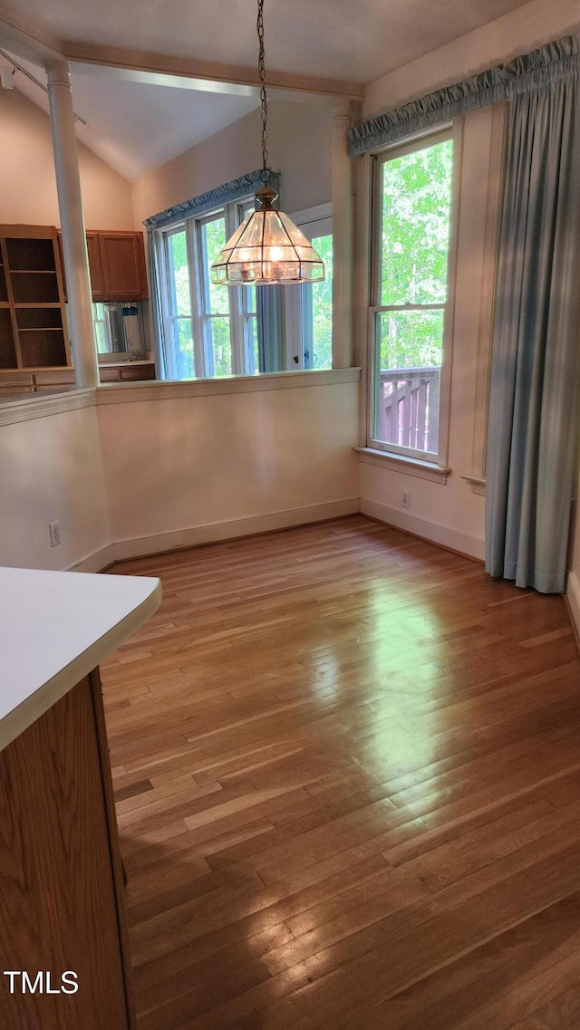 113 Colonial Dr, Wendell, NC 27591 - unfurnished dining area with light wood finished floors, vaulted ceiling, and baseboards