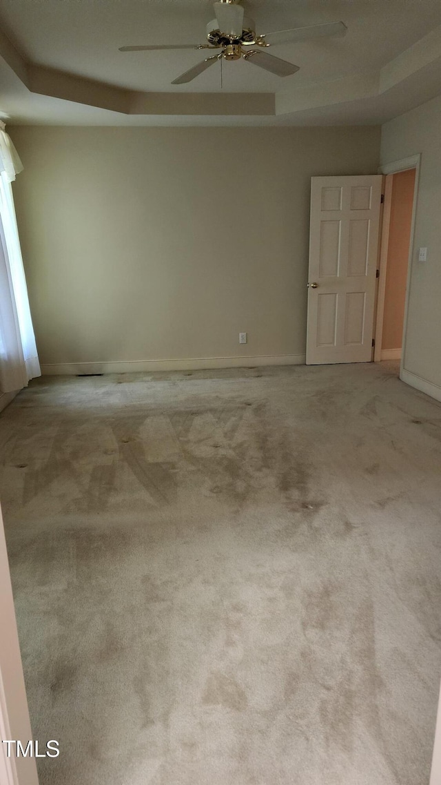 113 Colonial Dr, Wendell, NC 27591 - carpeted empty room featuring a ceiling fan, a raised ceiling, and baseboards
