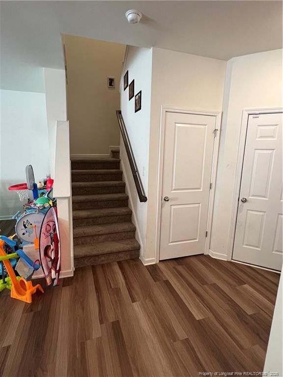 stairs featuring wood finished floors