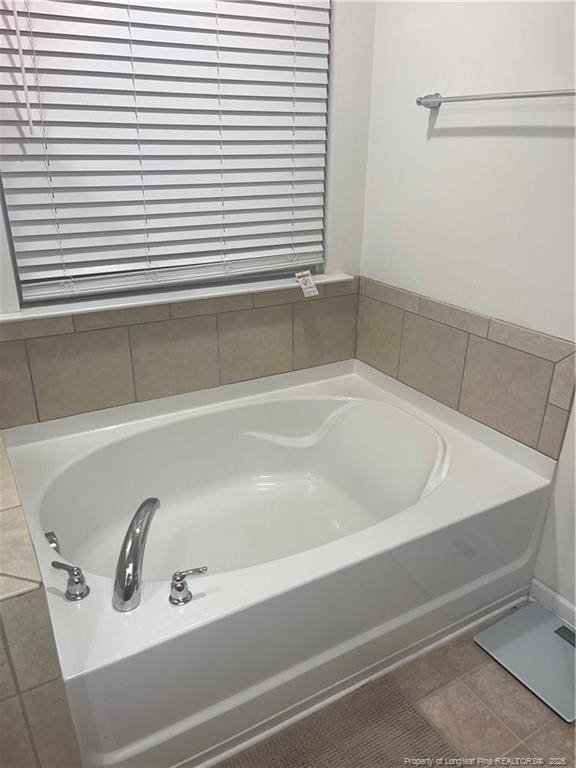 bathroom featuring a garden tub and tile patterned floors