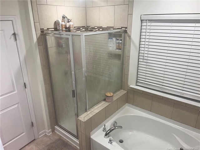 full bathroom with a garden tub, tile patterned flooring, and a stall shower