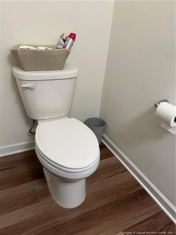 bathroom featuring baseboards, toilet, and wood finished floors