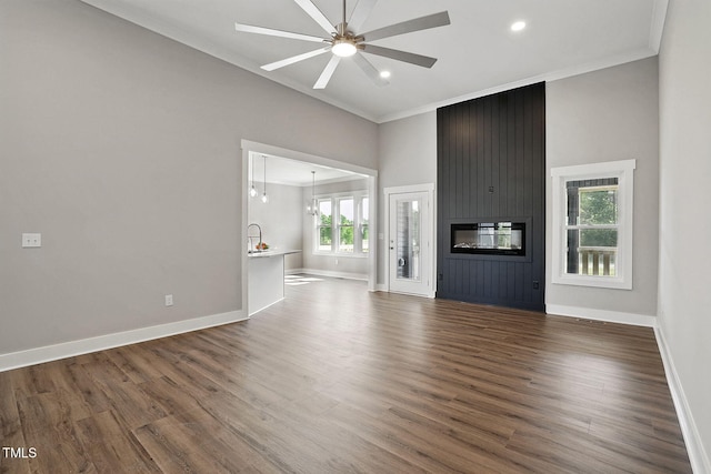 8629 Dukes Lake Rd, Zebulon, NC 27597 - unfurnished living room with crown molding, ceiling fan, dark wood-style flooring, a high ceiling, and recessed lighting