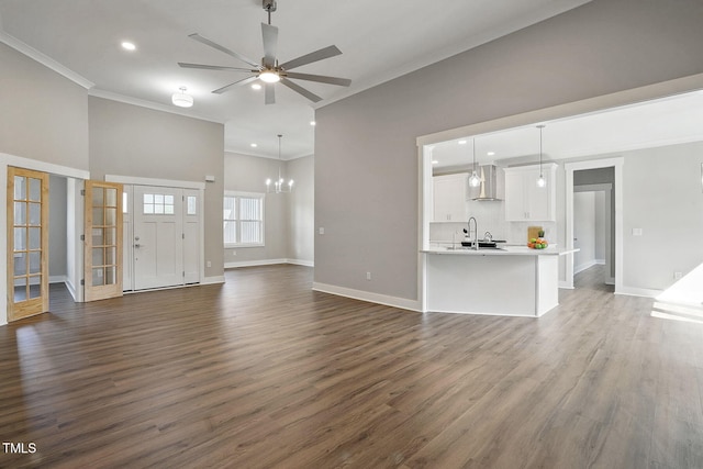 8629 Dukes Lake Rd, Zebulon, NC 27597 - unfurnished living room featuring ornamental molding, ceiling fan, dark wood-style flooring, recessed lighting, and a chandelier