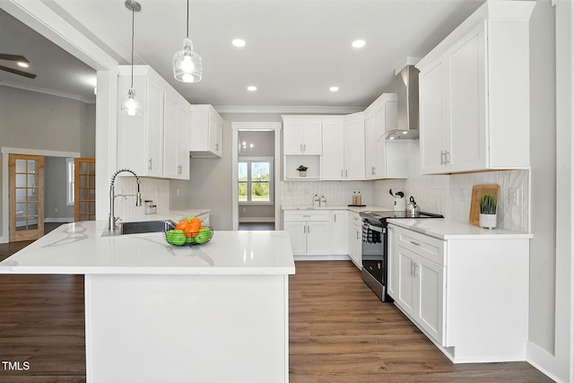 8629 Dukes Lake Rd, Zebulon, NC 27597 - kitchen featuring stainless steel range with electric stovetop, wall chimney exhaust hood, a peninsula, ornamental molding, and decorative backsplash