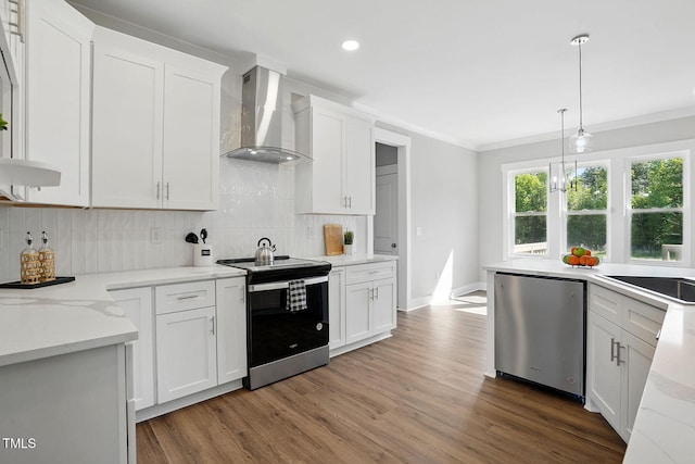8629 Dukes Lake Rd, Zebulon, NC 27597 - kitchen featuring wall chimney exhaust hood, appliances with stainless steel finishes, wood finished floors, crown molding, and backsplash