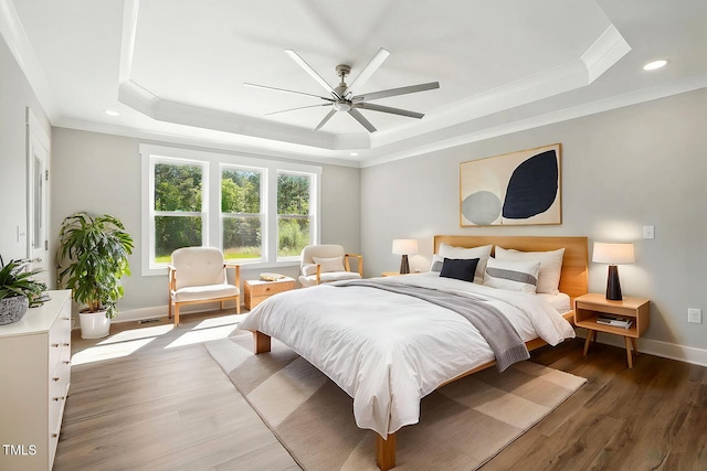 8629 Dukes Lake Rd, Zebulon, NC 27597 - bedroom featuring a raised ceiling, crown molding, wood finished floors, recessed lighting, and a ceiling fan