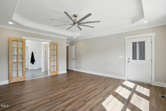 8629 Dukes Lake Rd, Zebulon, NC 27597 - empty room with a raised ceiling, ornamental molding, ceiling fan, wood finished floors, and recessed lighting