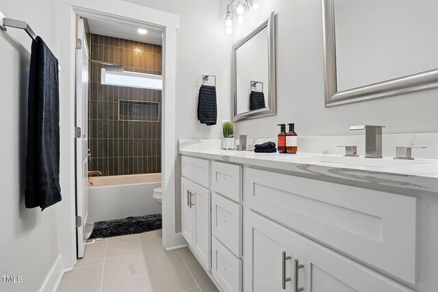 8629 Dukes Lake Rd, Zebulon, NC 27597 - bathroom with double vanity, tile patterned floors, and shower / tub combination