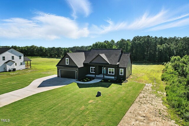 8629 Dukes Lake Rd, Zebulon, NC 27597 - view of front of home featuring concrete driveway, a front yard, and a shingled roof