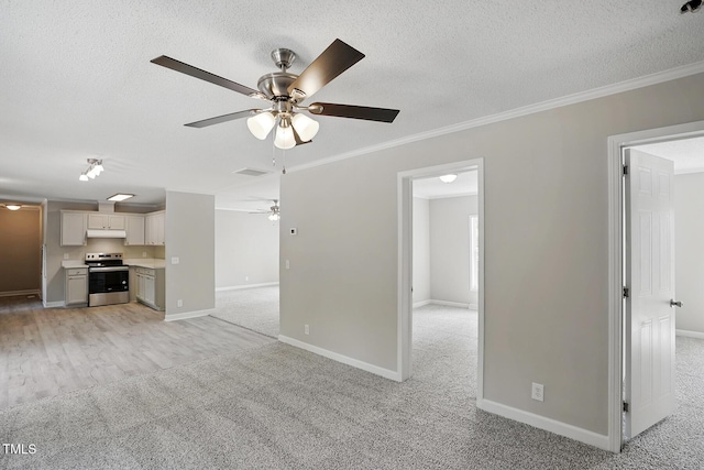 unfurnished living room with light colored carpet, a ceiling fan, a textured ceiling, and crown molding
