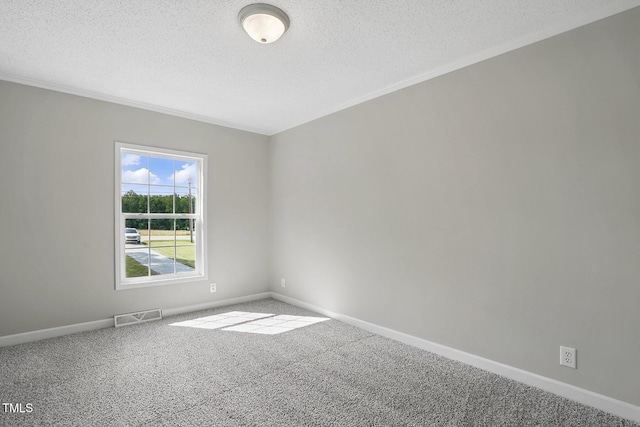 empty room featuring crown molding, carpet flooring, a textured ceiling, and visible vents
