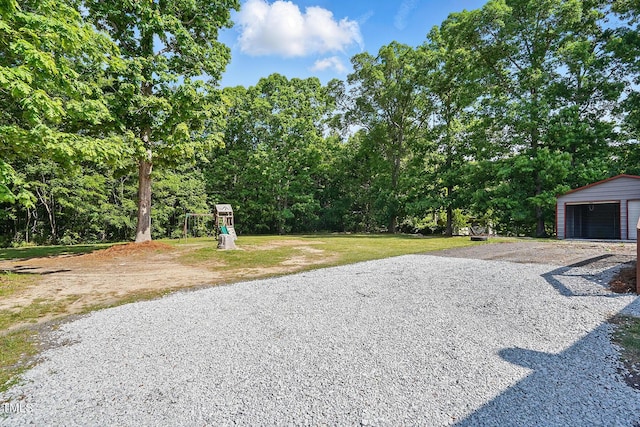 view of patio with a garage and an outdoor structure