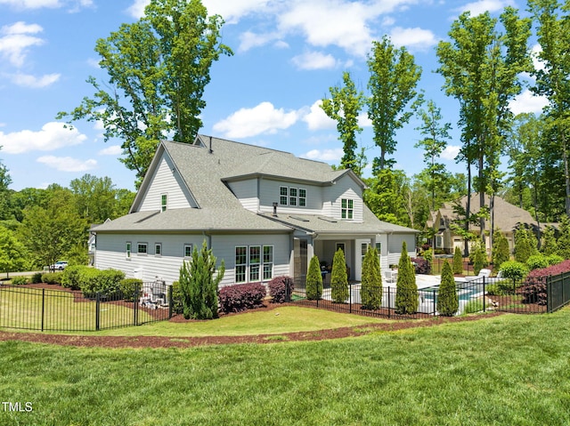 back of property with fence and a yard