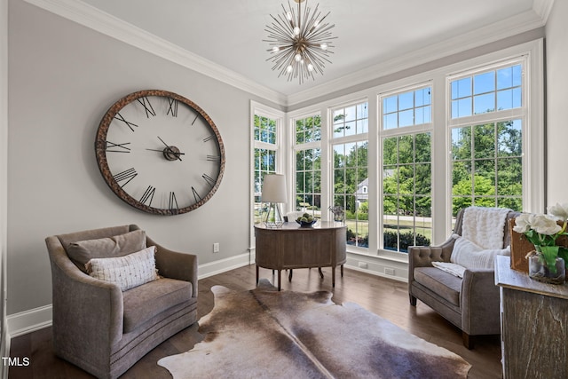 living area with baseboards, plenty of natural light, wood finished floors, and a chandelier