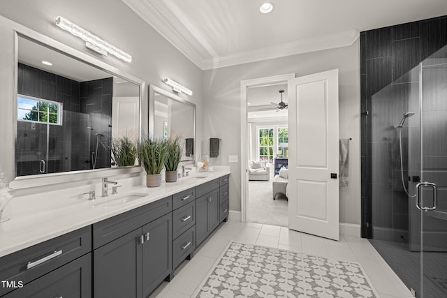 ensuite bathroom with crown molding, ceiling fan, a sink, double vanity, and a shower stall