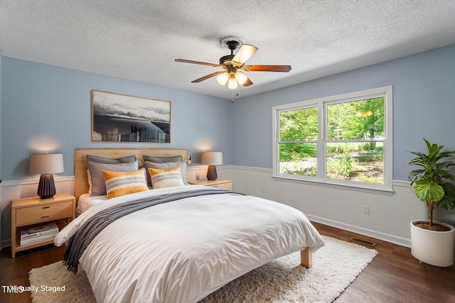 5124 Lazywood Ln, Durham, NC 27712 - bedroom with wood finished floors, a textured ceiling, and a ceiling fan