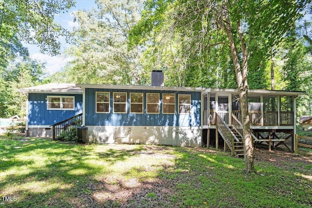 5124 Lazywood Ln, Durham, NC 27712 - rear view of house with a sunroom, stairs, a chimney, and a lawn