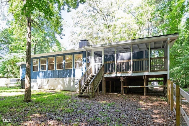 5124 Lazywood Ln, Durham, NC 27712 - back of property with a sunroom, stairs, and a chimney