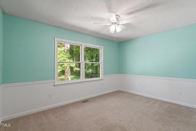 5124 Lazywood Ln, Durham, NC 27712 - carpeted empty room featuring ceiling fan, a textured ceiling, and a wainscoted wall