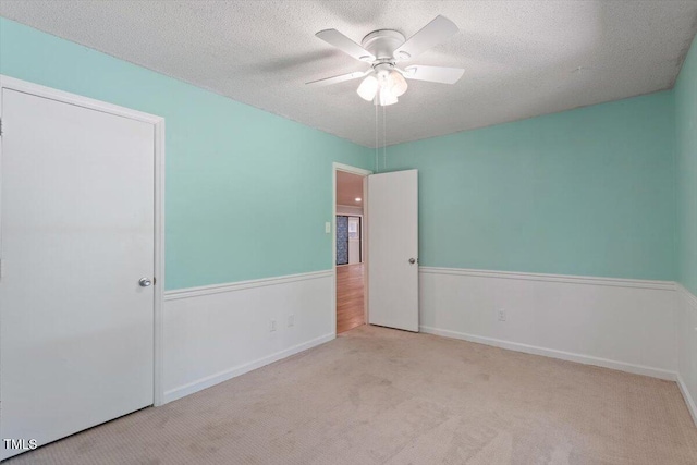 5124 Lazywood Ln, Durham, NC 27712 - unfurnished bedroom featuring carpet floors, a textured ceiling, and a ceiling fan