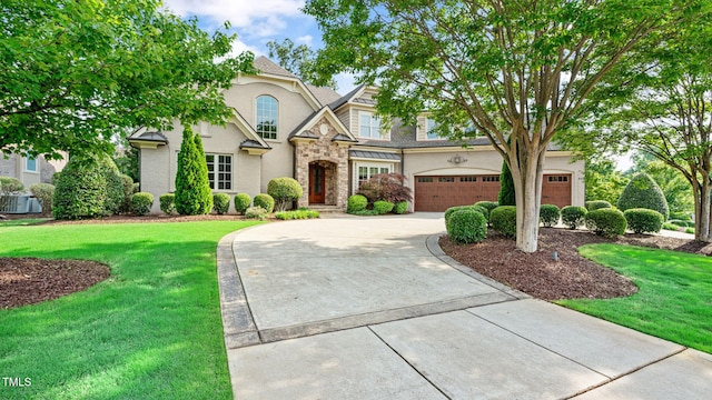 view of front facade featuring concrete driveway, stone siding, a front yard, and stucco siding